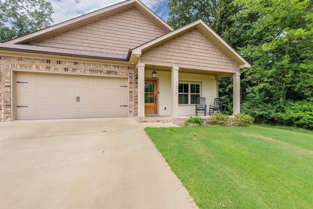181 Silver Leaf Ln, Florence, AL - view of front of house featuring covered porch, concrete driveway, a front lawn, a garage, and brick siding