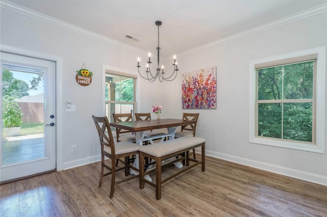 181 Silver Leaf Ln, Florence, AL - dining area featuring a chandelier, wood finished floors, healthy amount of natural light, and crown molding