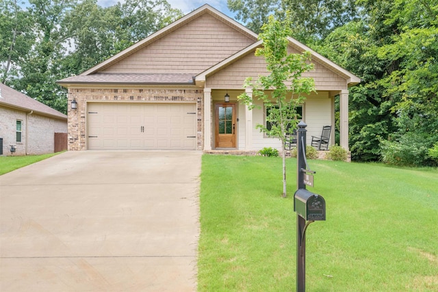 181 Silver Leaf Ln, Florence, AL - view of front facade featuring a front yard, concrete driveway, a garage, and brick siding