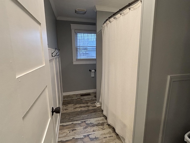 stairs with wood-type flooring and crown molding