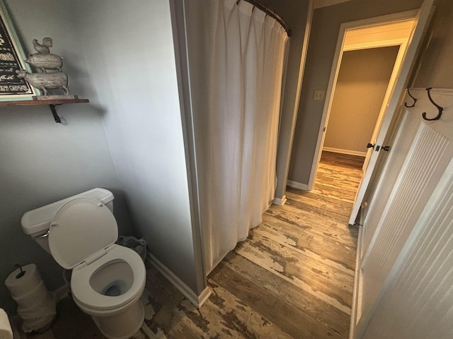 bathroom featuring toilet and hardwood / wood-style floors