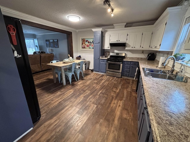 kitchen featuring a textured ceiling, white cabinets, gas stove, sink, and crown molding