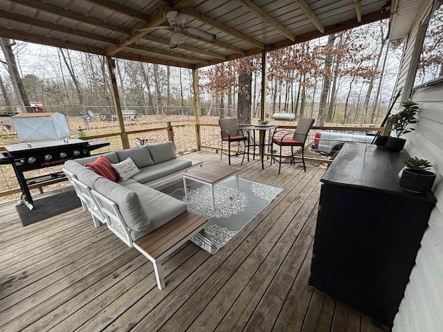 wooden terrace featuring ceiling fan and an outdoor hangout area