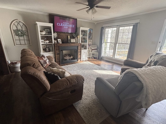 living room with ceiling fan, a textured ceiling, and crown molding