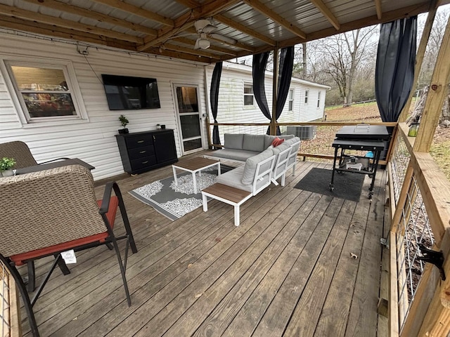 wooden terrace with ceiling fan and an outdoor hangout area