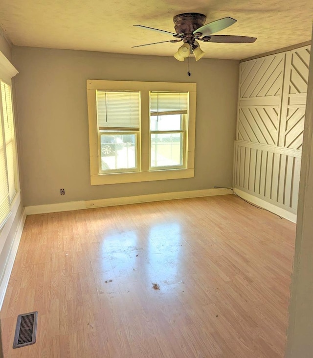  - unfurnished room featuring a ceiling fan and light wood-style floors