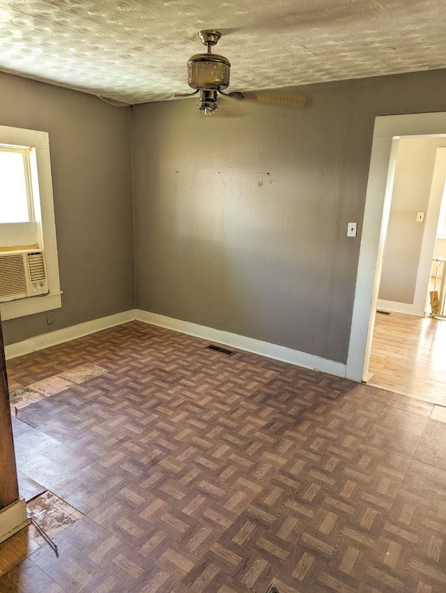  - unfurnished room featuring ceiling fan, cooling unit, and a textured ceiling