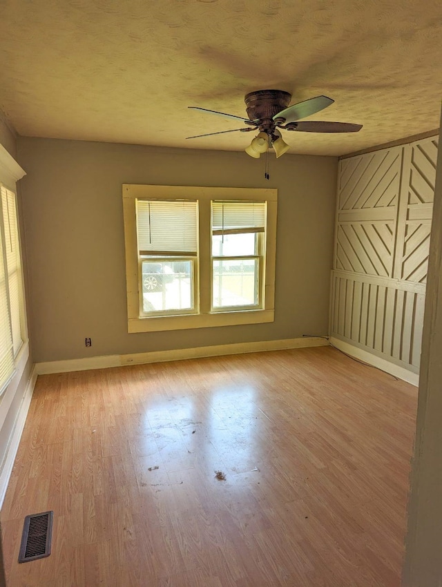  - unfurnished room with ceiling fan and wood finished floors