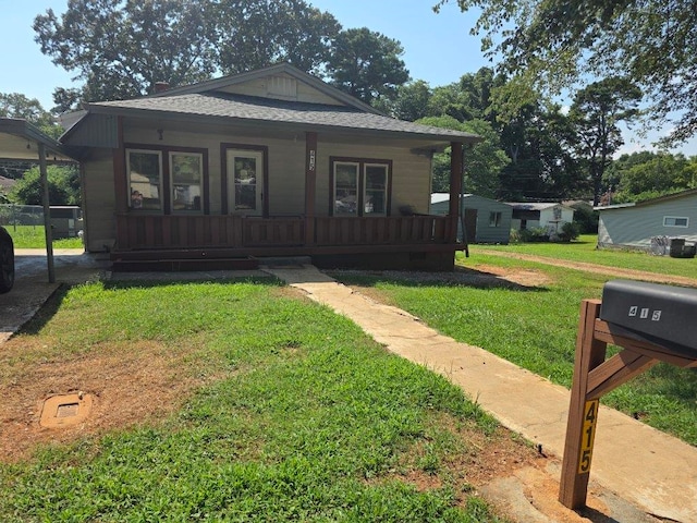  - view of front of property with covered porch and a front yard
