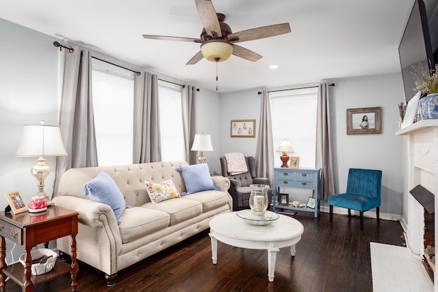  - living area with a ceiling fan, hardwood / wood-style floors, recessed lighting, baseboards, and a brick fireplace