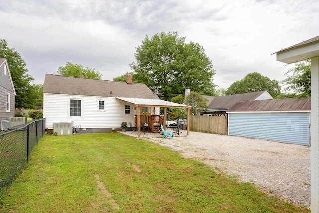  - rear view of house with central AC, a chimney, a patio, and driveway