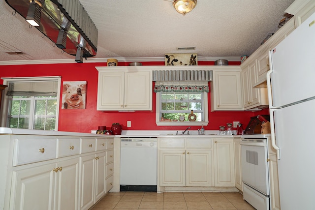  - kitchen with white appliances, a textured ceiling, light tile patterned floors, light countertops, and ornamental molding