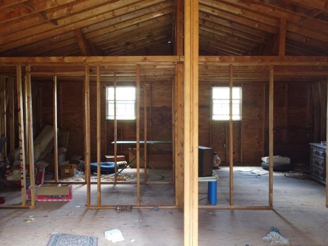  - misc room with healthy amount of natural light and vaulted ceiling