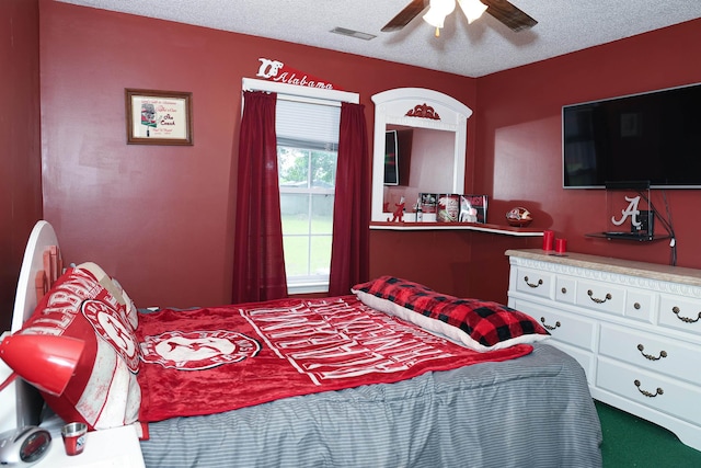  - bedroom featuring a textured ceiling, a ceiling fan, and carpet