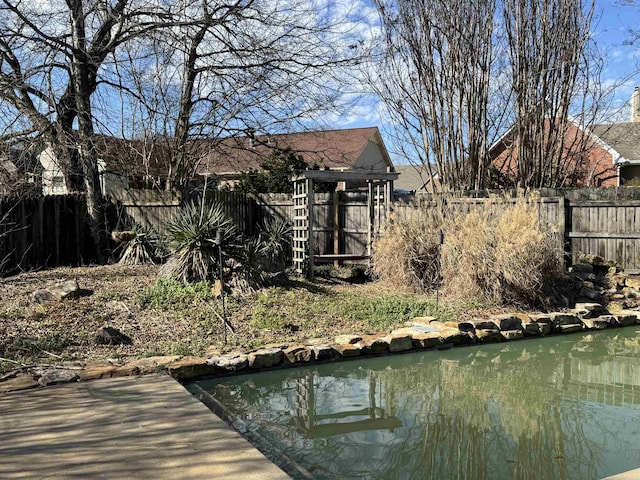 view of dock featuring a fenced backyard