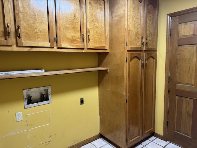 laundry room with light tile patterned flooring, hookup for an electric dryer, washer hookup, baseboards, and cabinet space