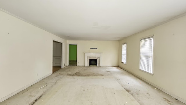  - unfurnished living room with a fireplace and baseboards