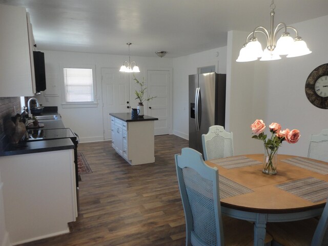 kitchen featuring hardwood / wood-style flooring, white cabinetry, tasteful backsplash, and stainless steel electric range