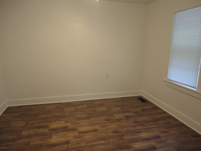 spare room featuring dark hardwood / wood-style flooring