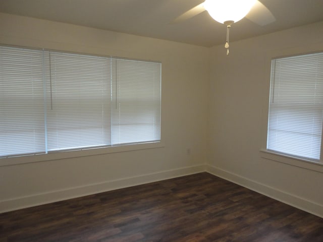 spare room featuring ceiling fan and dark wood-type flooring