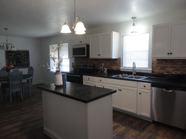 kitchen featuring white cabinets, sink, appliances with stainless steel finishes, tasteful backsplash, and dark hardwood / wood-style flooring