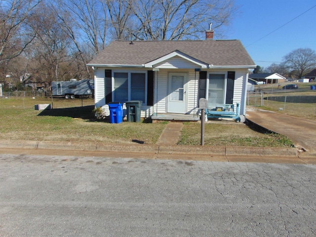 bungalow-style home with a front yard