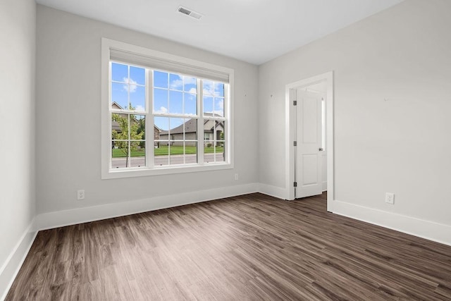 empty room with dark hardwood / wood-style floors