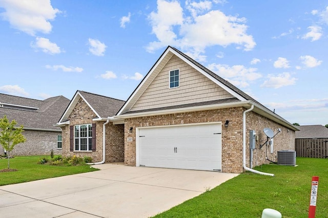 view of front of property with a garage, central AC, and a front yard