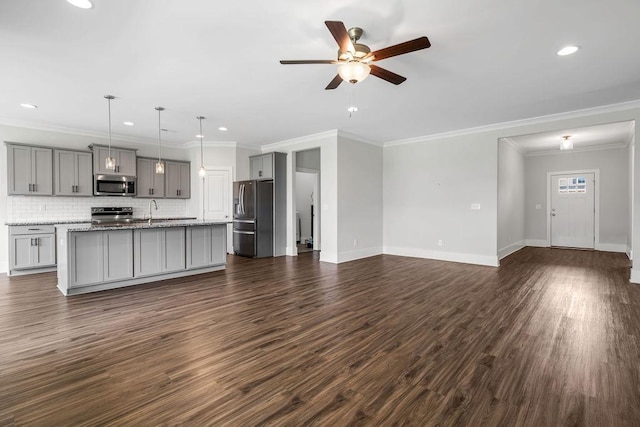 unfurnished living room featuring ceiling fan, ornamental molding, dark hardwood / wood-style floors, and sink