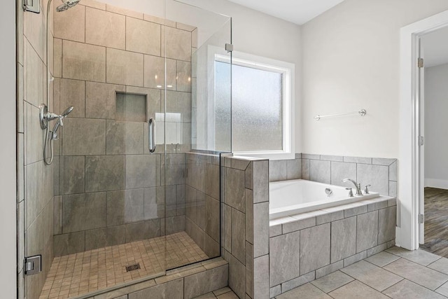 bathroom with tile patterned floors and plus walk in shower