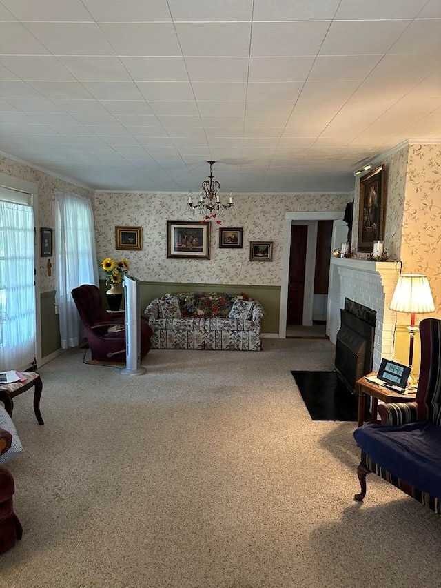 carpeted living room featuring a fireplace and an inviting chandelier