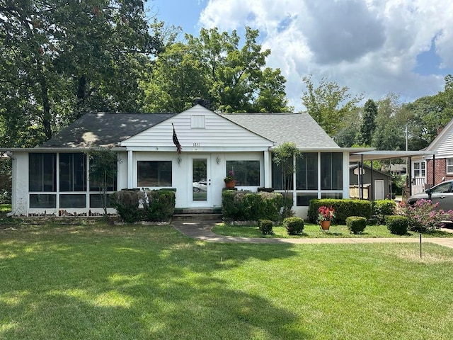 view of front of property featuring a sunroom and a front yard