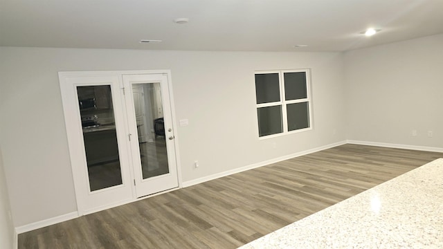 unfurnished room featuring wood-type flooring