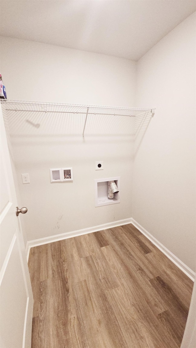 washroom with hardwood / wood-style flooring, hookup for a washing machine, and hookup for an electric dryer