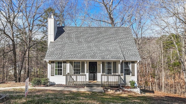 cape cod home with a porch and a chimney