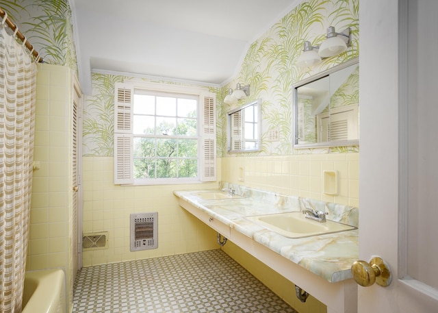  - bathroom featuring tile walls, wallpapered walls, heating unit, and ornamental molding