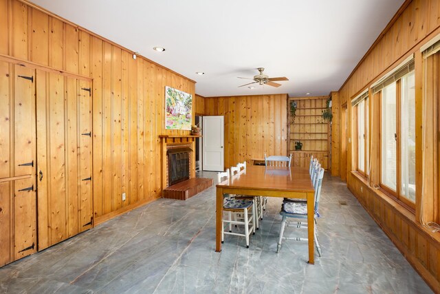  - dining room with a fireplace, wood walls, ceiling fan, and recessed lighting