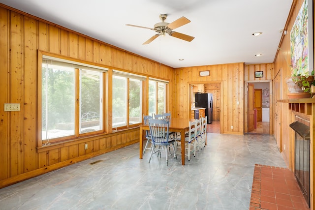  - dining room featuring wood walls, recessed lighting, and ceiling fan