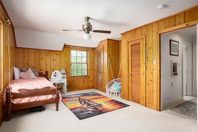 - carpeted bedroom with baseboards, a ceiling fan, crown molding, and wooden walls