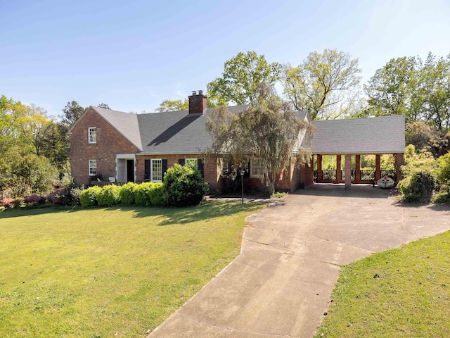  - view of front of house featuring concrete driveway, brick siding, a chimney, and a front yard