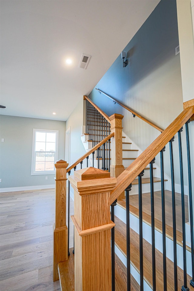 staircase with hardwood / wood-style flooring