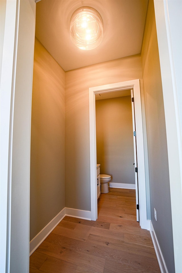 bathroom with hardwood / wood-style floors and toilet