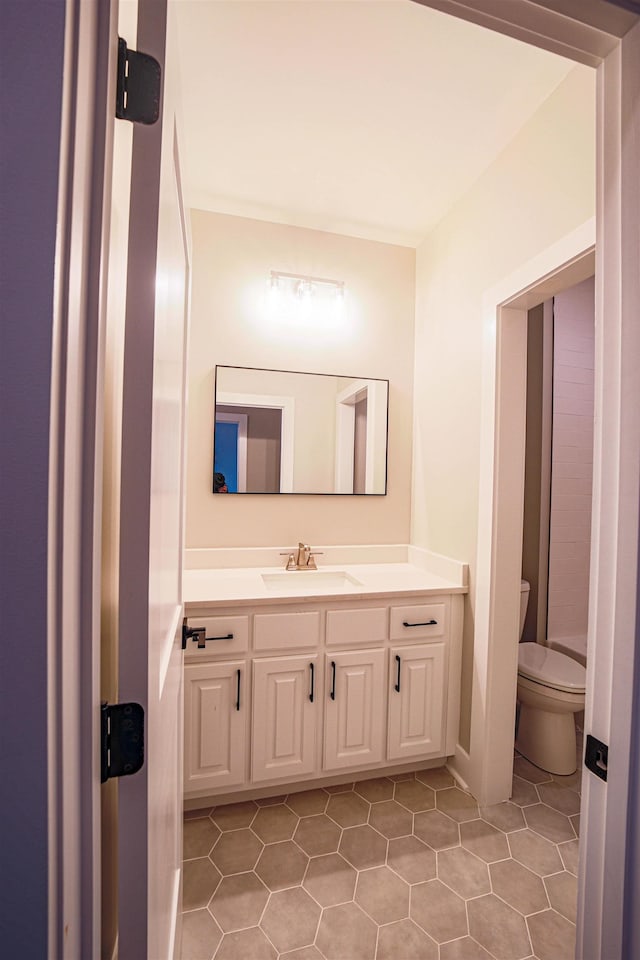 bathroom with tile patterned floors, vanity, and toilet