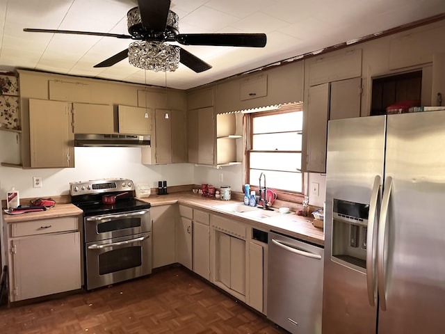  - kitchen featuring appliances with stainless steel finishes, under cabinet range hood, ceiling fan, and light countertops