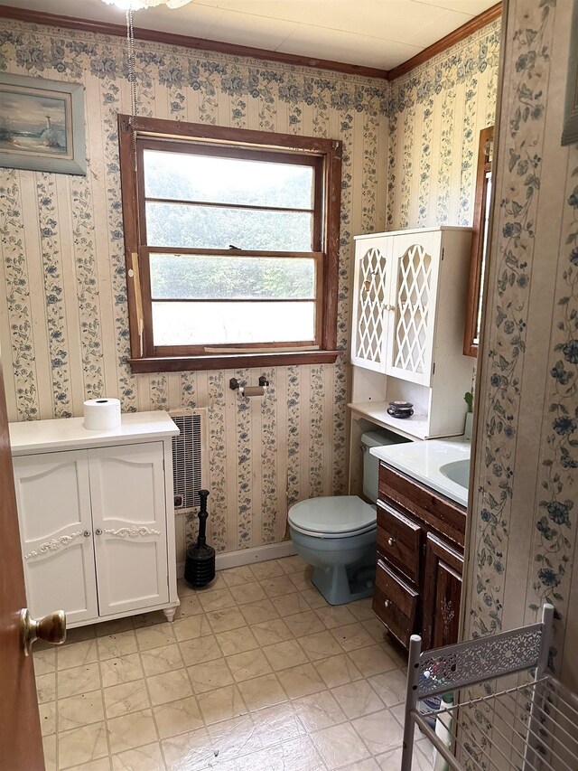  - bathroom with vanity, plenty of natural light, wallpapered walls, and crown molding