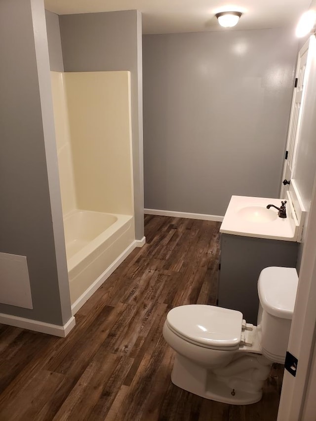 full bathroom featuring vanity, wood finished floors, toilet, and baseboards