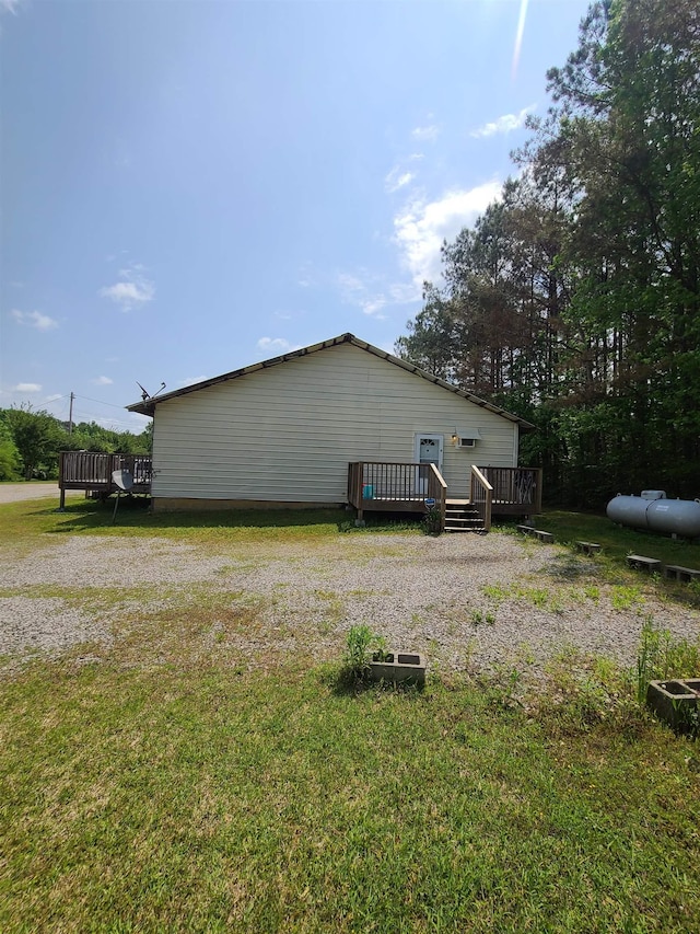 view of property exterior with a yard and a deck