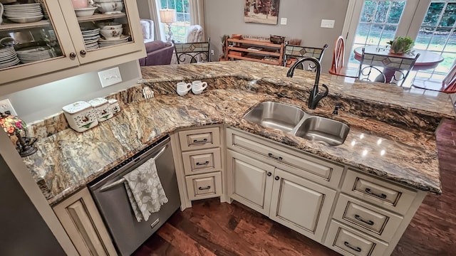 kitchen with dishwasher, light stone counters, a healthy amount of sunlight, and sink