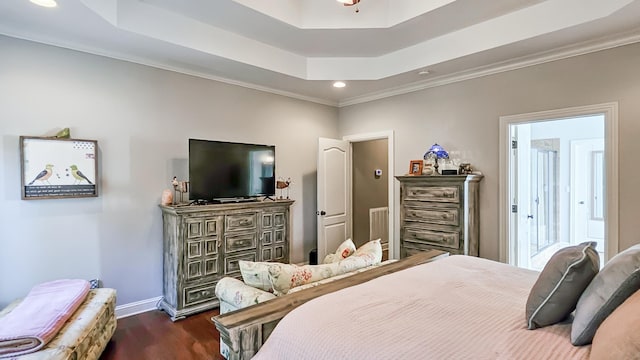 bedroom featuring a tray ceiling, crown molding, and dark hardwood / wood-style flooring