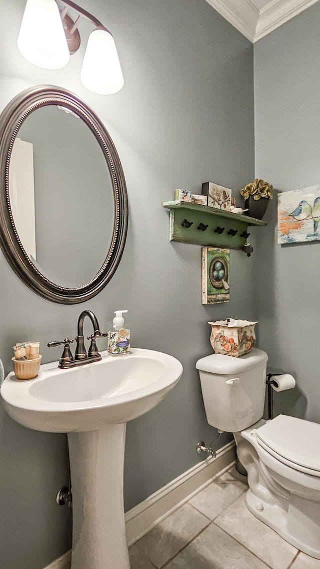 bathroom with tile patterned flooring, sink, toilet, and crown molding